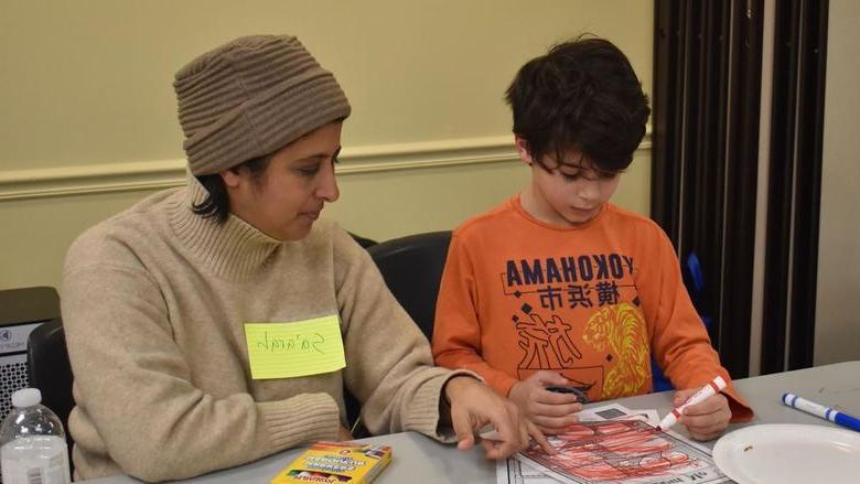 Parent and child completing worksheets